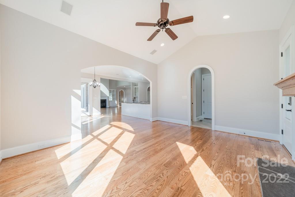 144 Greyfriars Road Mooresville, NC 28117 - Photo 19 of 43 a bedroom with a bed ceiling fan and a wooden floor