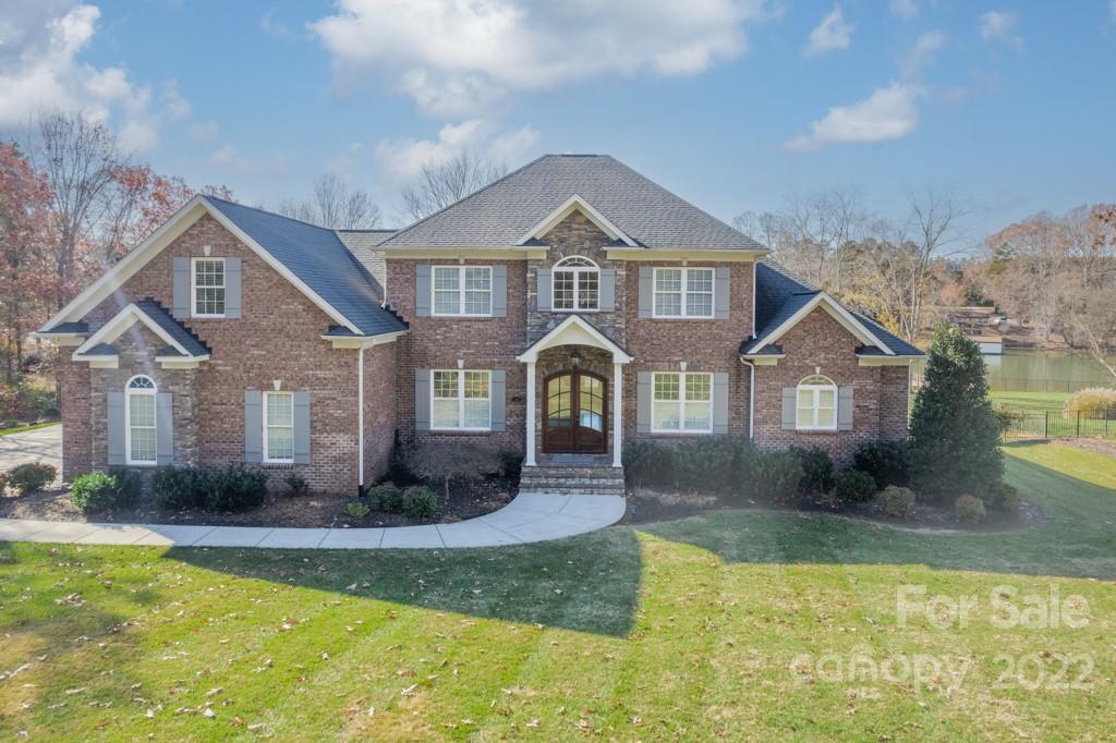 144 Greyfriars Road Mooresville, NC 28117 - Photo 2 of 43 a front view of a house with a yard and garage