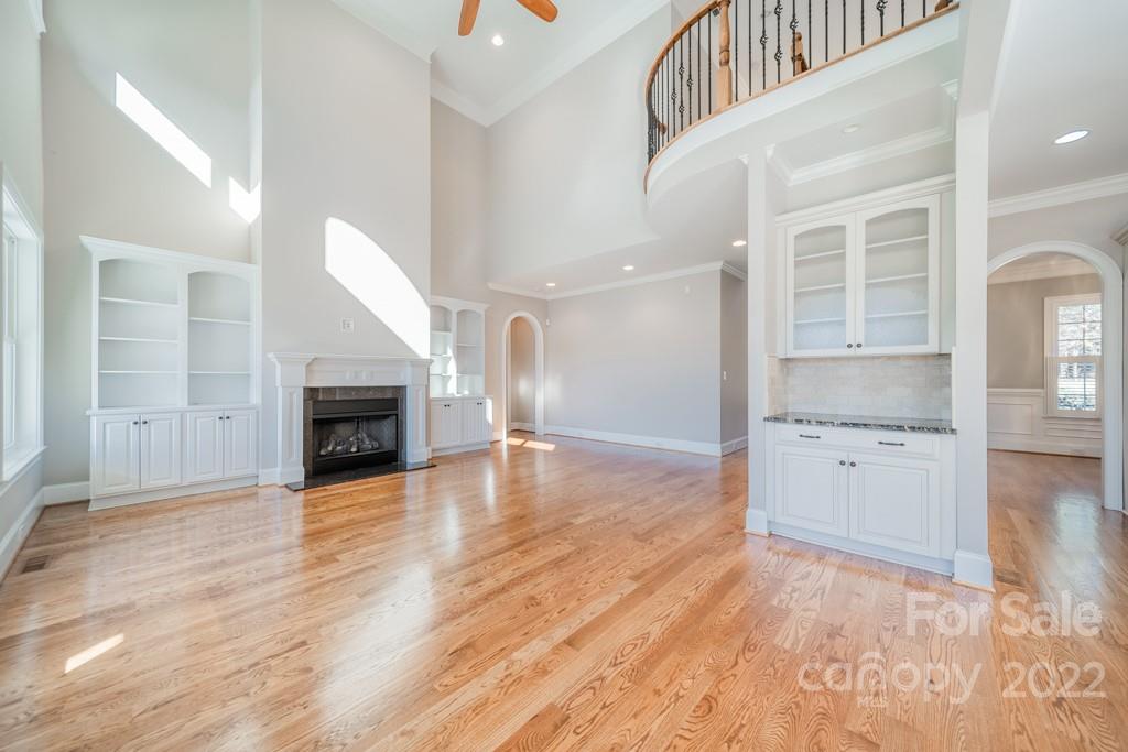 144 Greyfriars Road Mooresville, NC 28117 - Photo 21 of 43 an empty room with wooden floor and fireplace