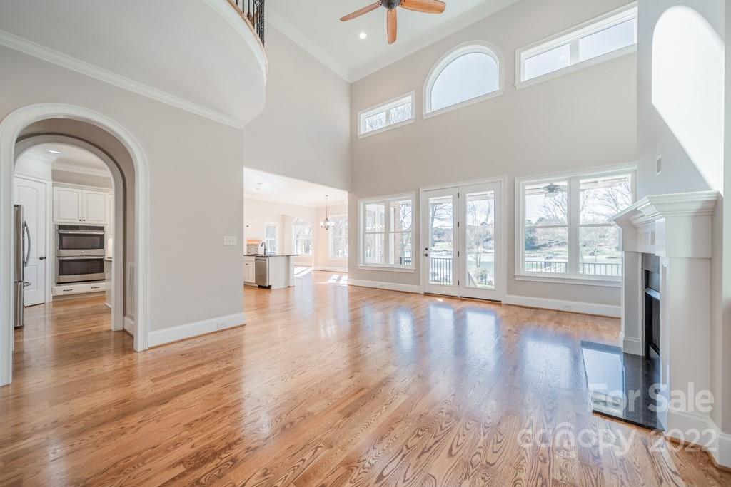 144 Greyfriars Road Mooresville, NC 28117 - Photo 23 of 43 a view of empty room with wooden floor and fireplace