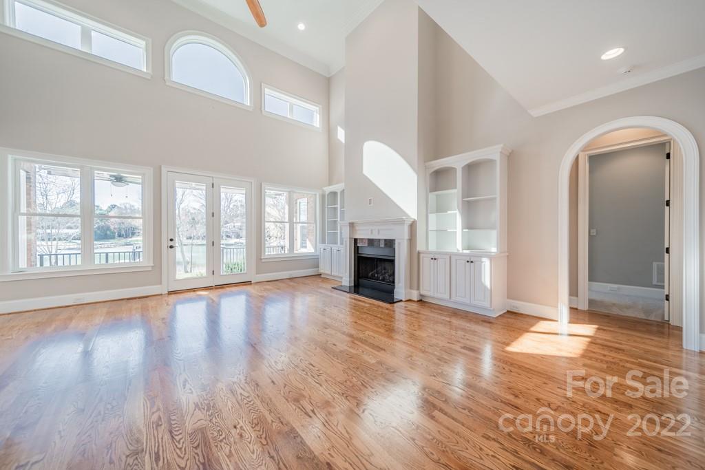 144 Greyfriars Road Mooresville, NC 28117 - Photo 24 of 43 a view of an empty room with wooden floor and a window