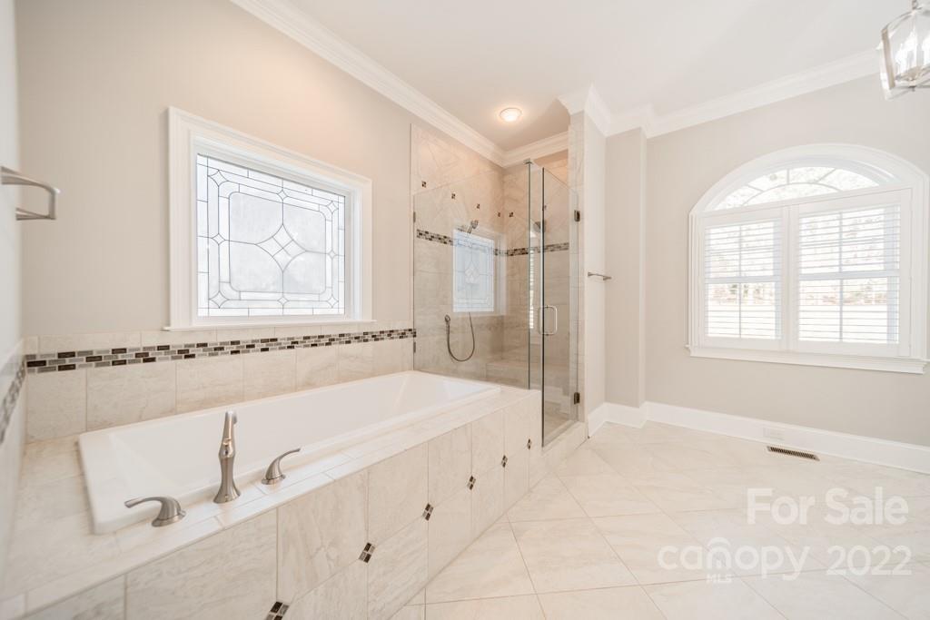 144 Greyfriars Road Mooresville, NC 28117 - Photo 26 of 43 a bathroom with a bathtub and a shower
