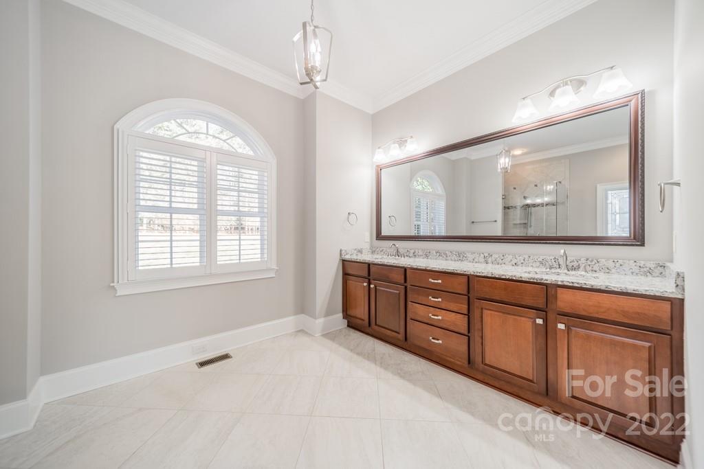 144 Greyfriars Road Mooresville, NC 28117 - Photo 27 of 43 a spacious bathroom with a granite countertop double vanity sink and a mirror