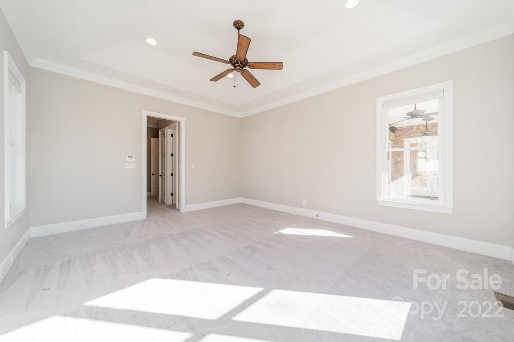 144 Greyfriars Road Mooresville, NC 28117 - Photo 28 of 43 a view of a livingroom with a ceiling fan & windows