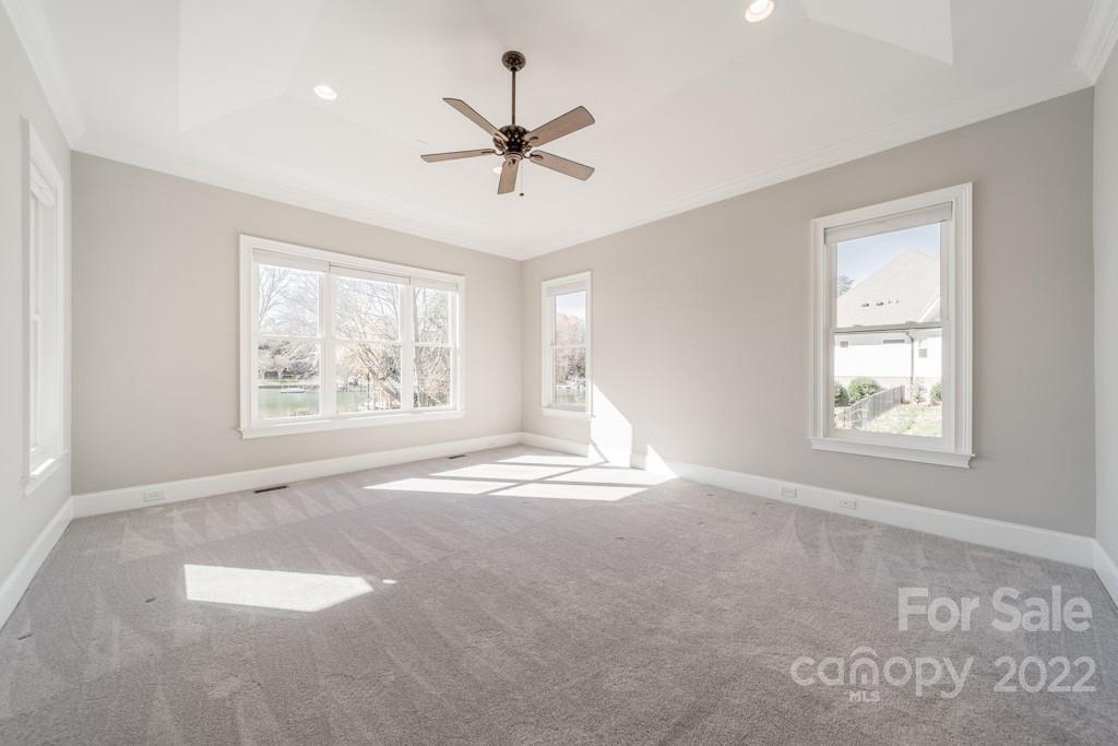 144 Greyfriars Road Mooresville, NC 28117 - Photo 29 of 43 an empty room with windows and ceiling fan