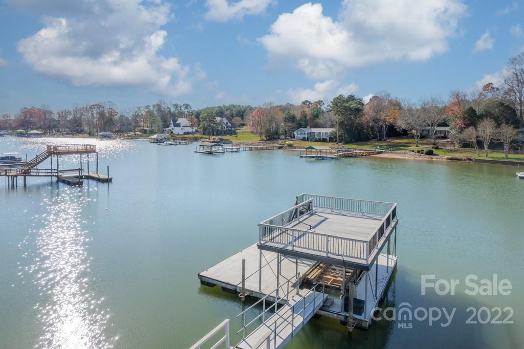 144 Greyfriars Road Mooresville, NC 28117 - Photo 37 of 43 a view of a lake with a table and chairs