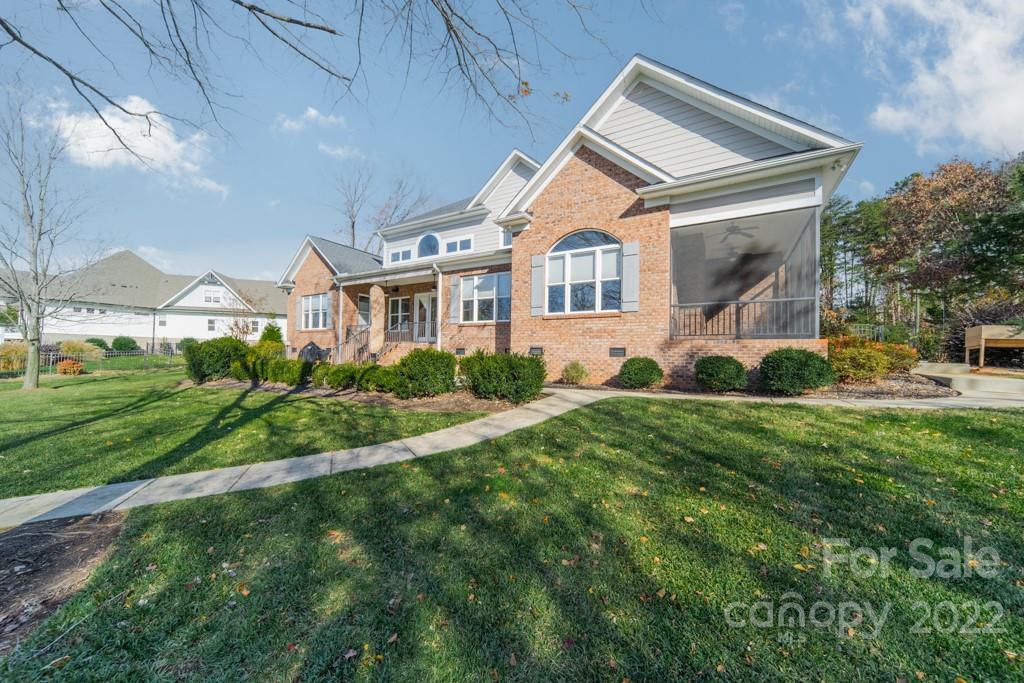 144 Greyfriars Road Mooresville, NC 28117 - Photo 4 of 43 a front view of a house with a yard and trees