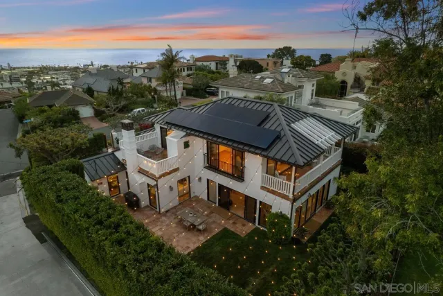 an aerial view of multiple houses with a yard