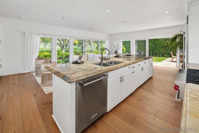 a kitchen with a stove and a wooden floor