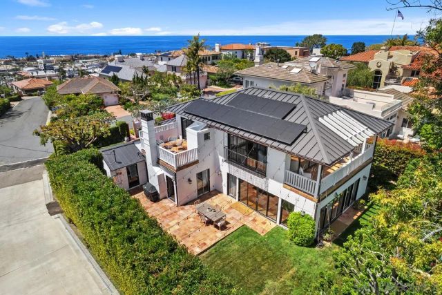 an aerial view of multiple houses with a yard