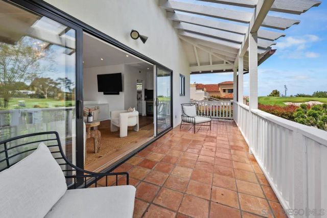 a view of a balcony with furniture