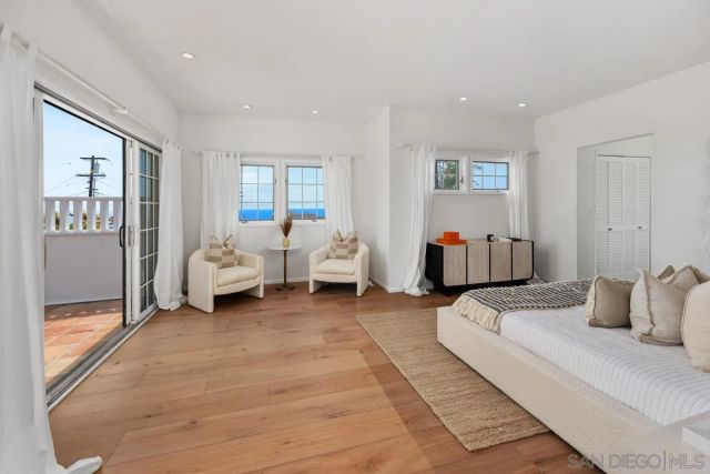 a bedroom with bed and white cabinets