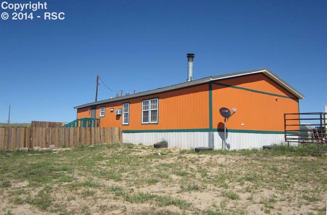 15640 South Lauppe Road Yoder, CO 80864 - Photo 11 of 12 Looking at the rear of the house with the back yard fenced for kids & pets.