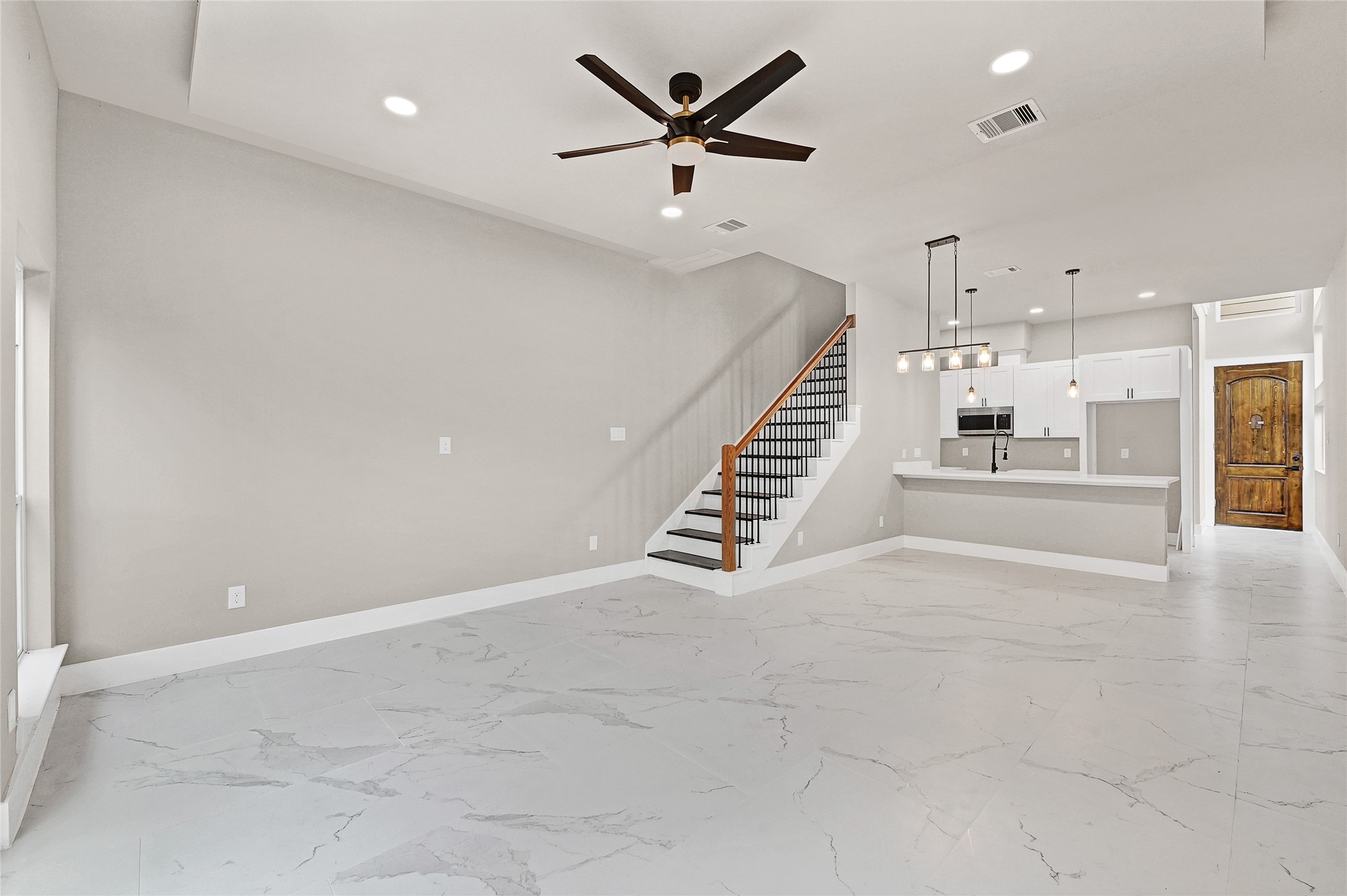 7938 Angus Street Houston, TX 77028 - Photo 11 of 25 an empty room with a ceiling fan and wooden floor