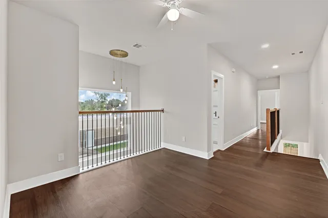 a view of a hallway with wooden floor