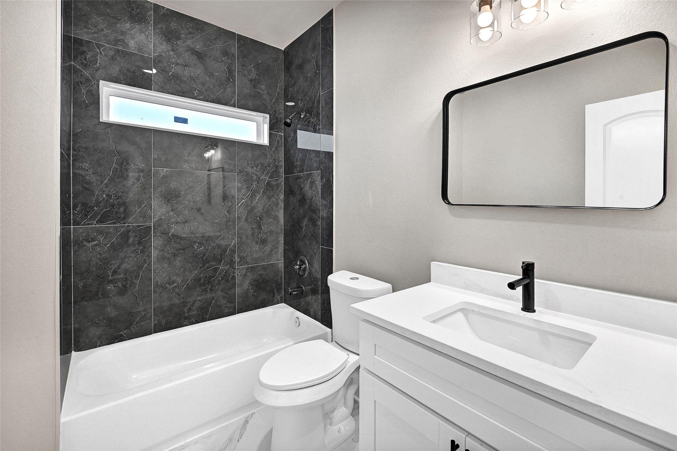 7938 Angus Street Houston, TX 77028 - Photo 13 of 25 a bathroom with a sink a toilet and shower