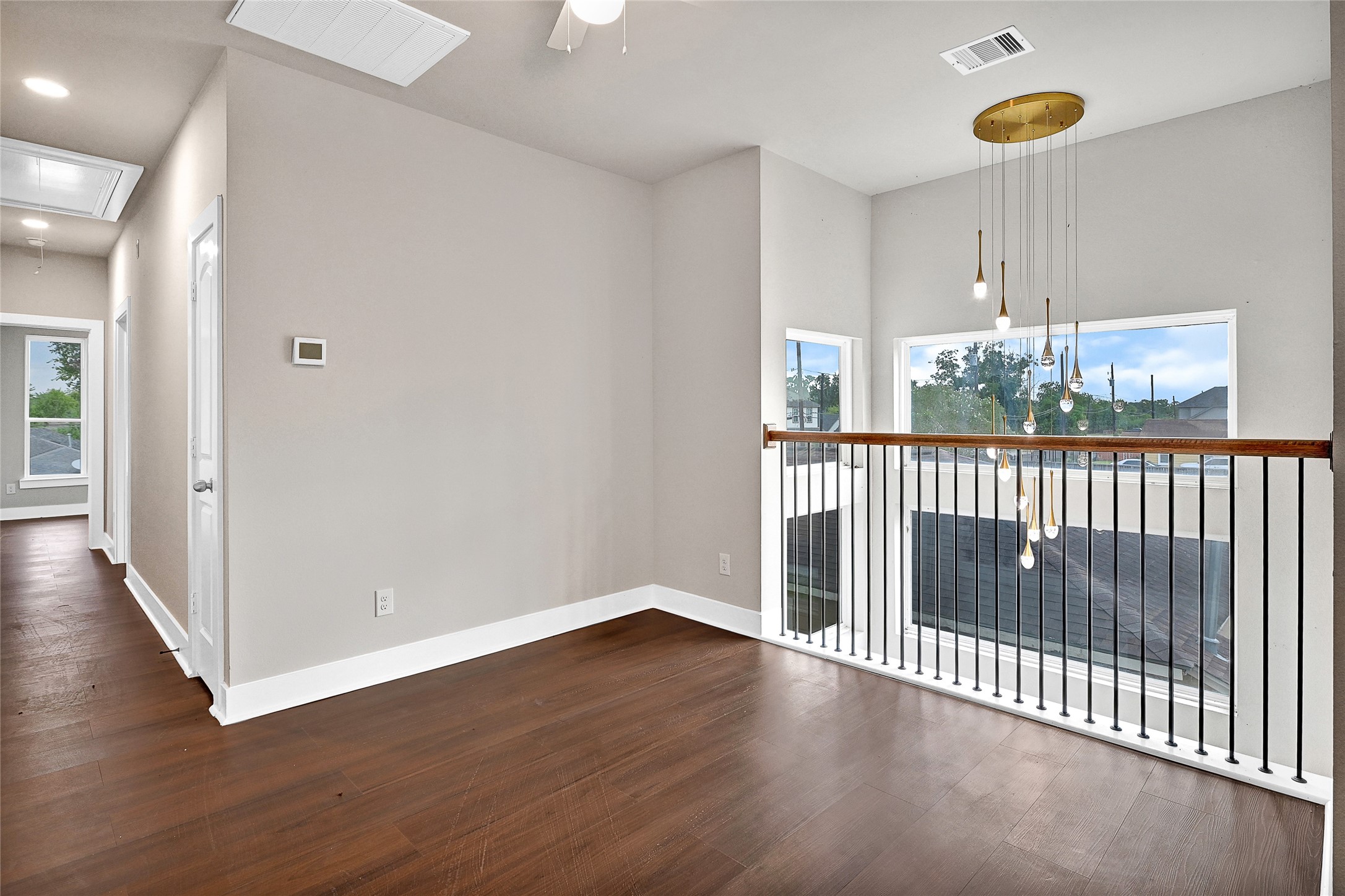 7938 Angus Street Houston, TX 77028 - Photo 14 of 25 a view of a room with wooden floor windows and a chandelier
