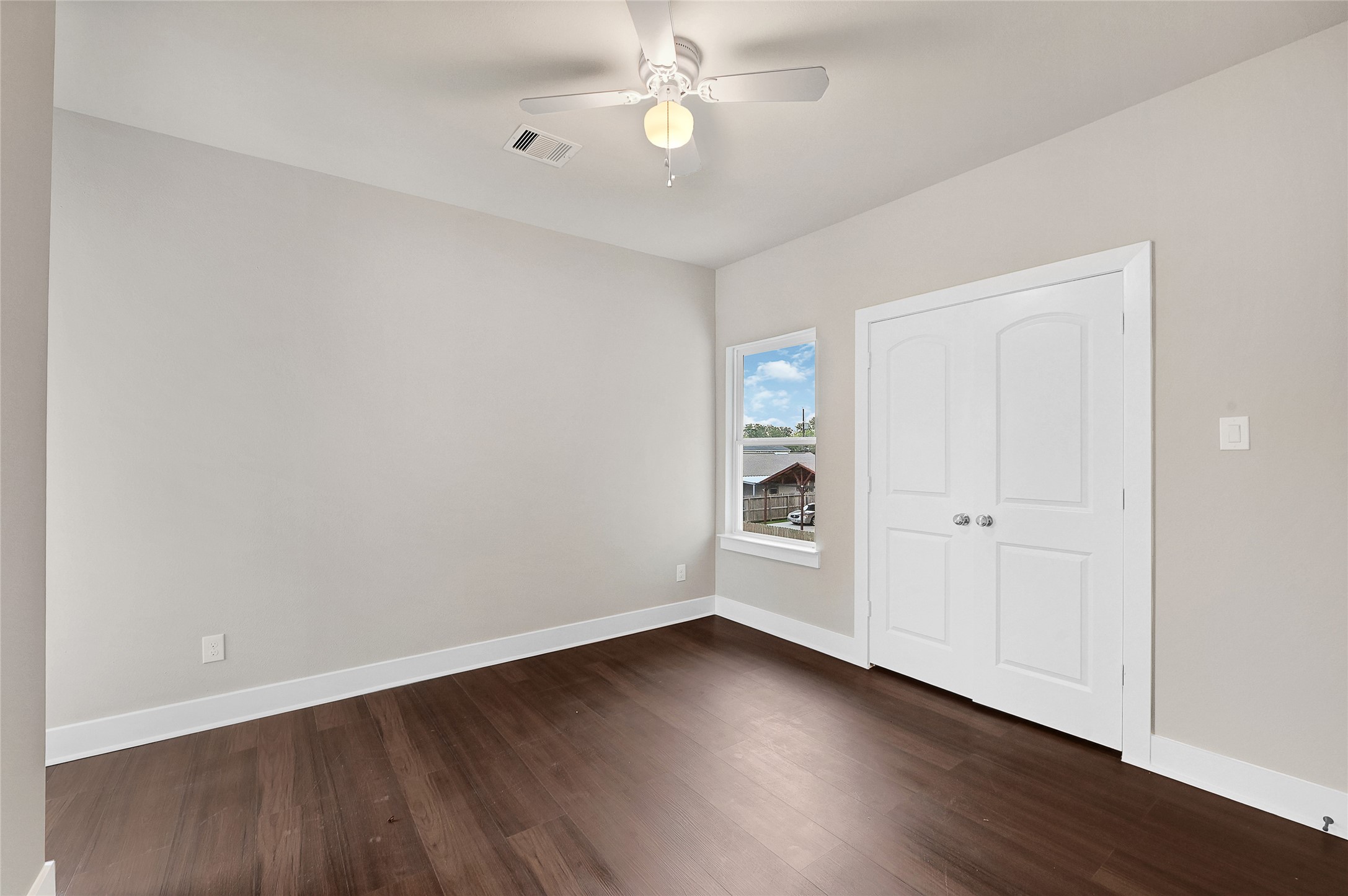 7938 Angus Street Houston, TX 77028 - Photo 15 of 25 an empty room with wooden floor closet and windows