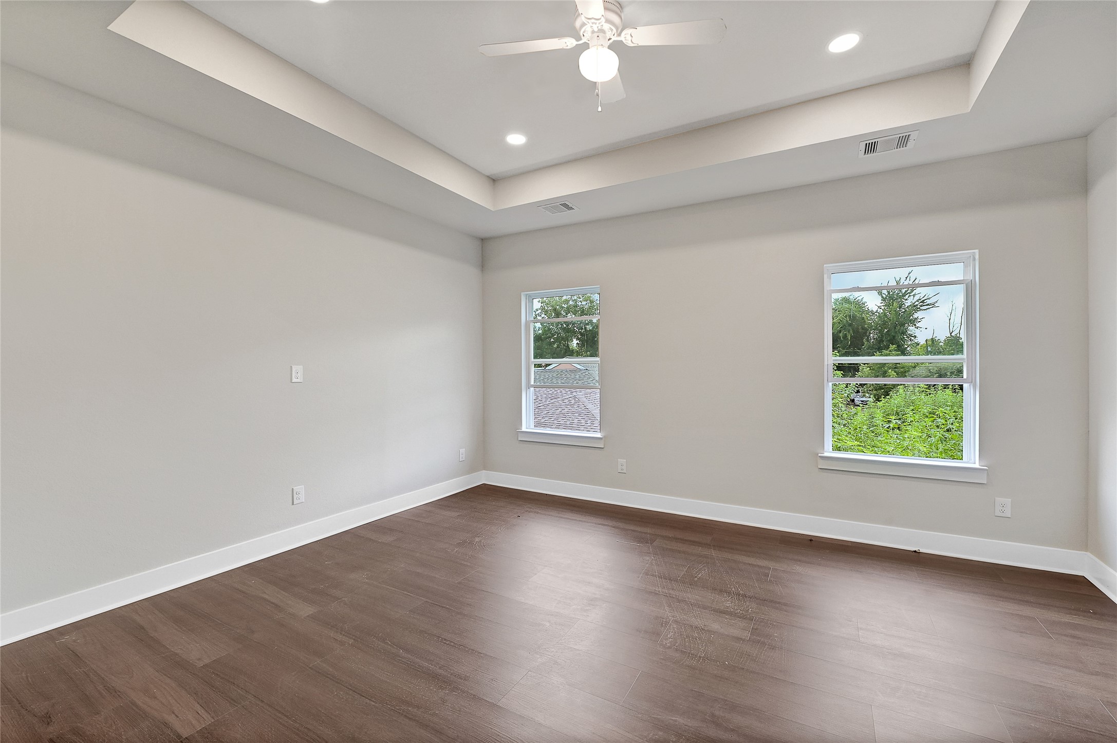 7938 Angus Street Houston, TX 77028 - Photo 19 of 25 an empty room with wooden floor and windows