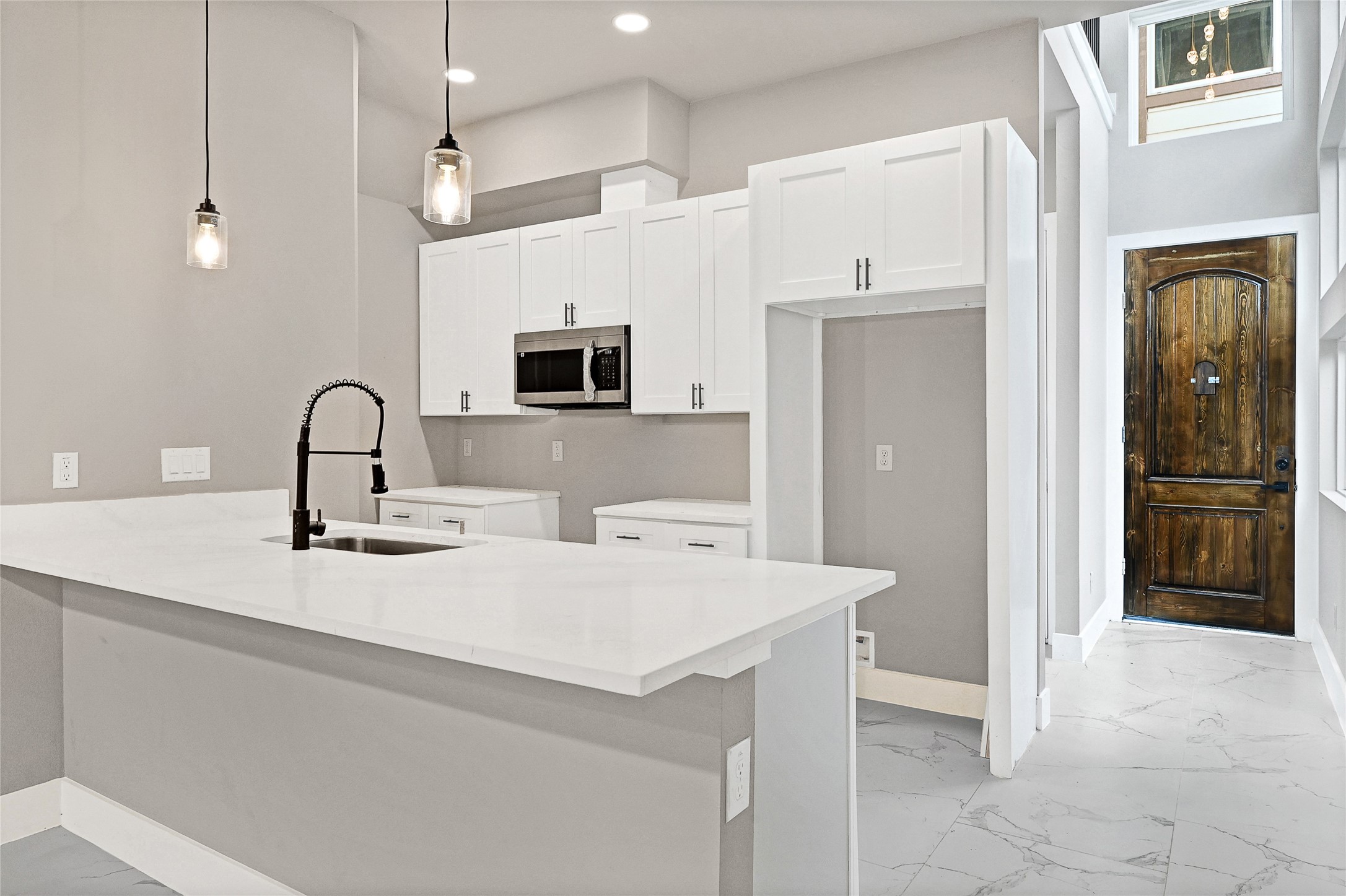 7938 Angus Street Houston, TX 77028 - Photo 4 of 25 a kitchen with a sink a refrigerator and cabinets