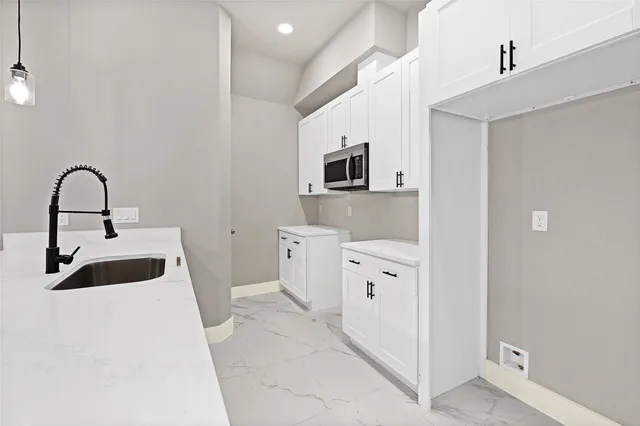 a kitchen with stainless steel appliances a sink a stove and a refrigerator