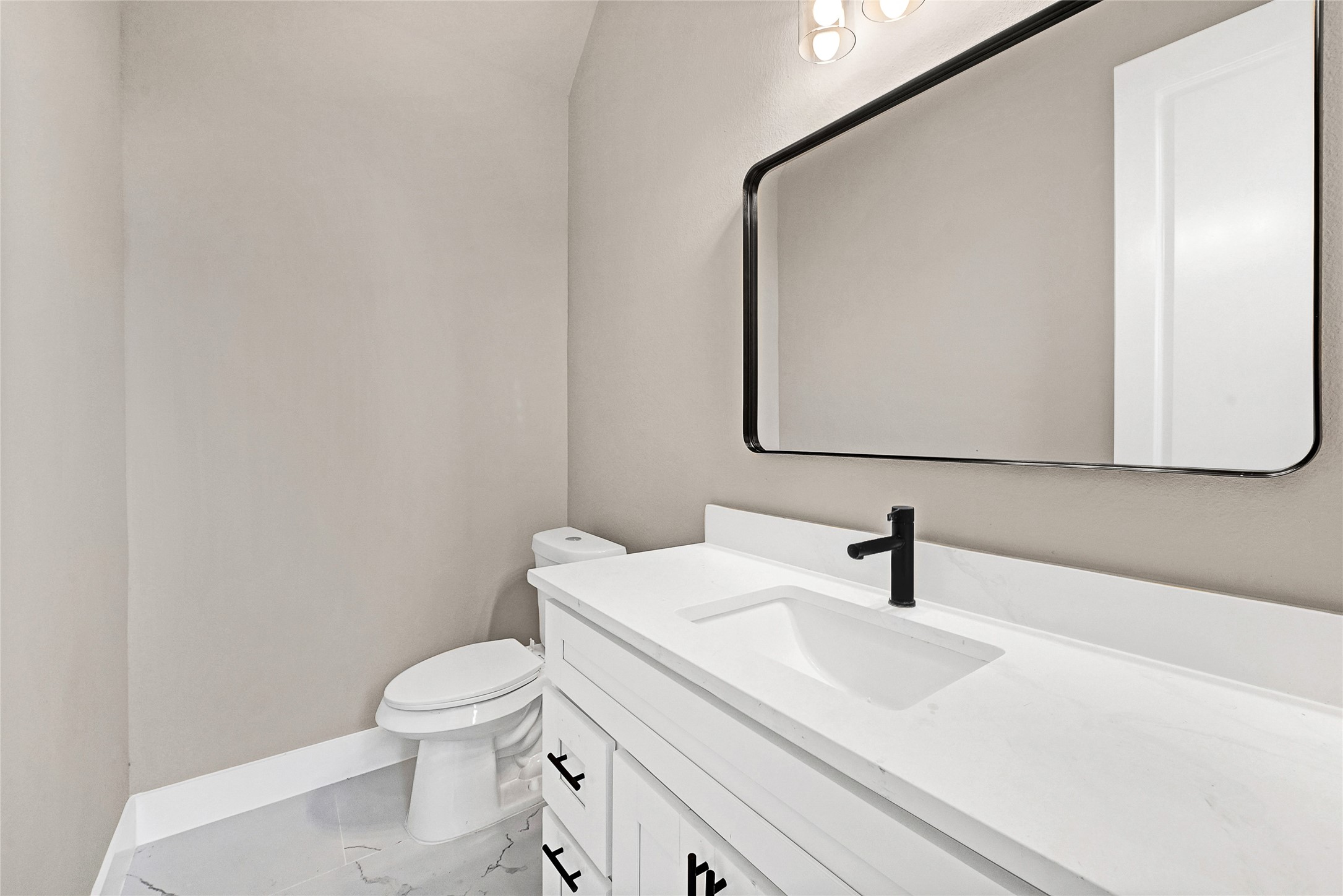 7938 Angus Street Houston, TX 77028 - Photo 7 of 25 a bathroom with a toilet sink and mirror