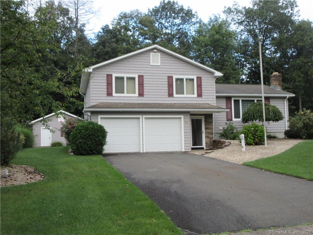66 Pequot Road Plainville, CT 06062 - Photo 1 of 1 a front view of a house with a garden and yard