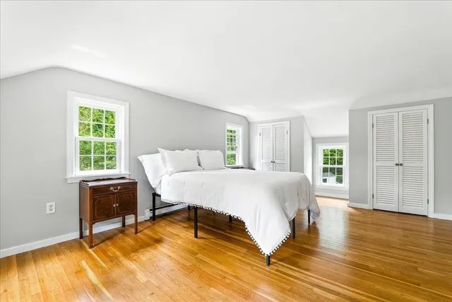 a view of an empty room with wooden staircase