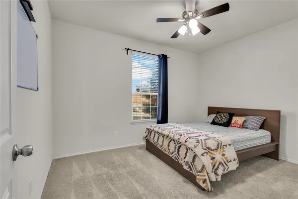 a view of a hallway with a livingroom and a bedroom