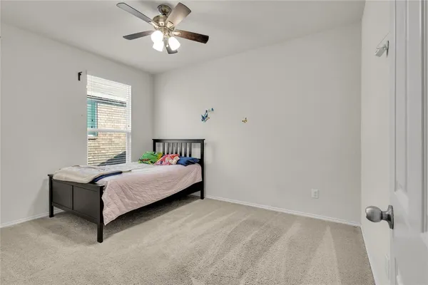 a bathroom with a sink vanity mirror and toilet