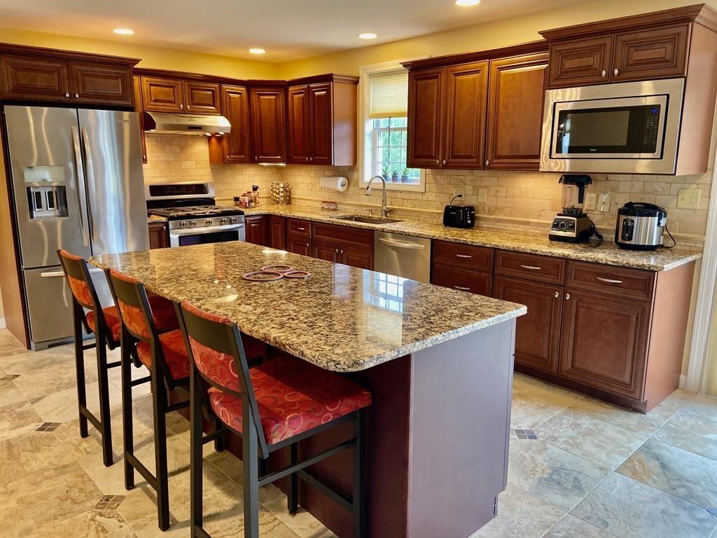 152 Plumtree Road Sunderland, MA 01375 - Photo 13 of 34 a kitchen with stainless steel appliances granite countertop a stove a sink a microwave and a refrigerator