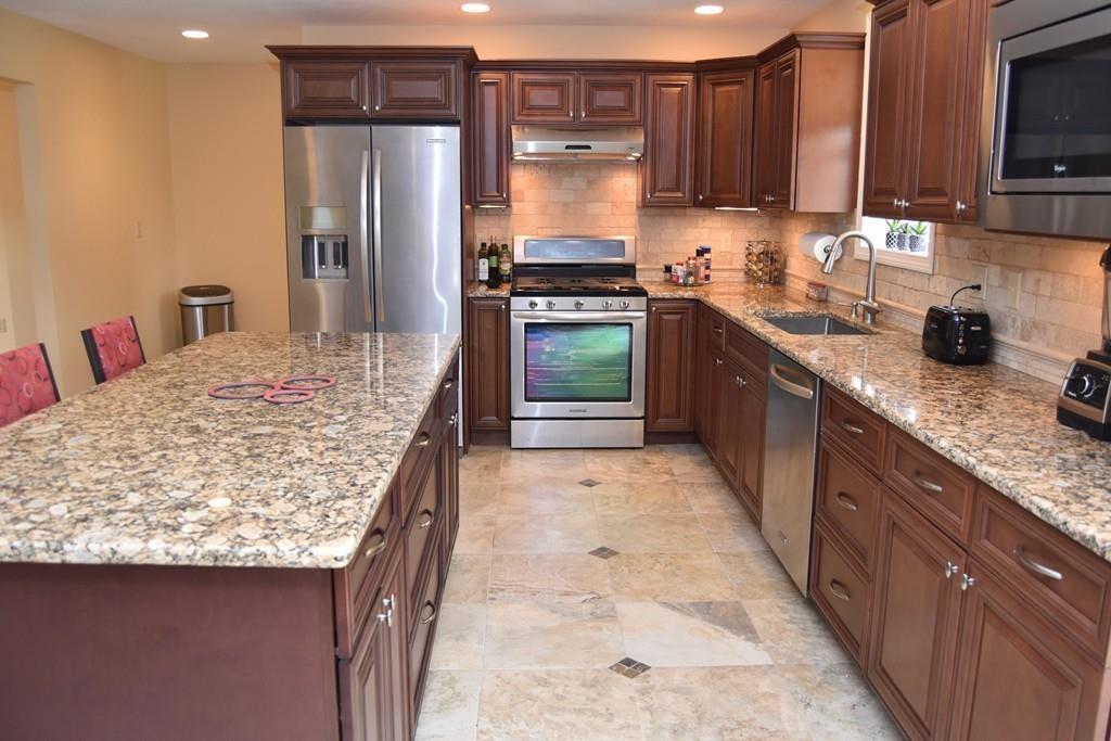 152 Plumtree Road Sunderland, MA 01375 - Photo 14 of 34 a kitchen with stainless steel appliances kitchen island granite countertop a sink stove and refrigerator