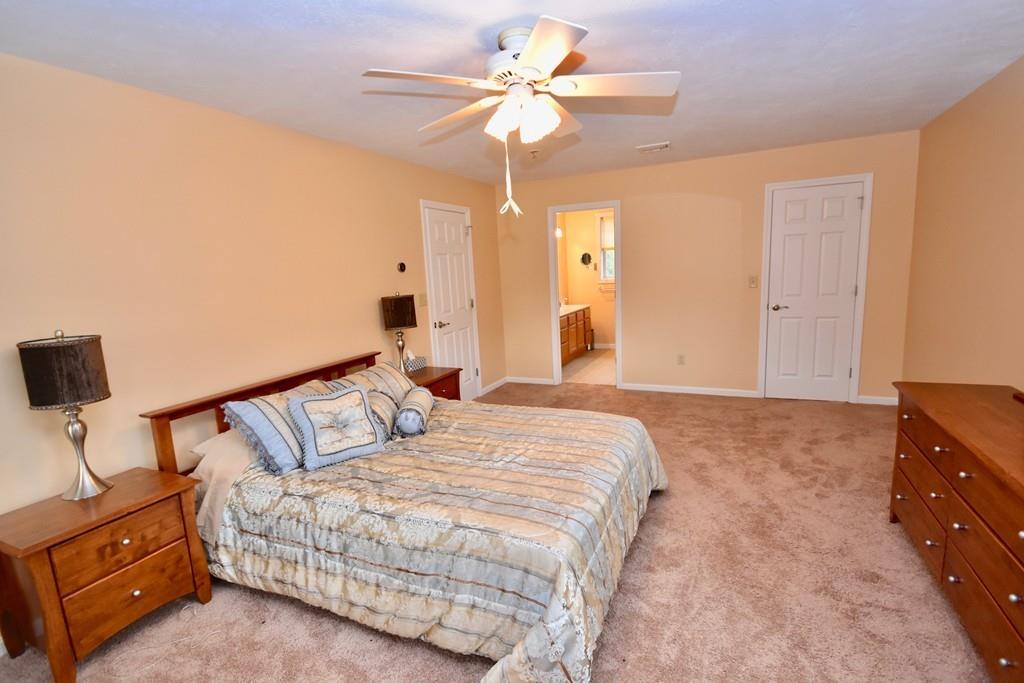 152 Plumtree Road Sunderland, MA 01375 - Photo 18 of 34 a bedroom with a bed and a chandelier