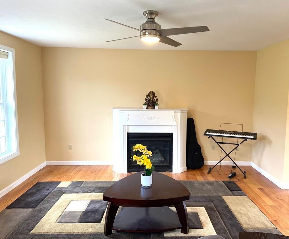 152 Plumtree Road Sunderland, MA 01375 - Photo 7 of 34 a view of a livingroom with furniture wooden floor a fireplace and windows