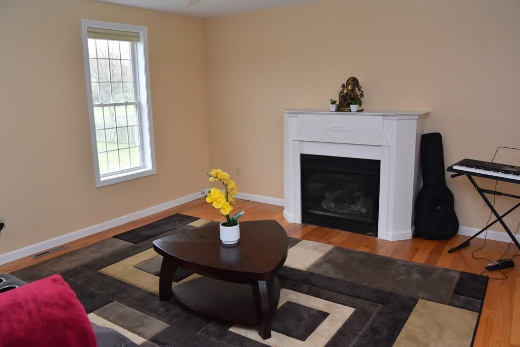 152 Plumtree Road Sunderland, MA 01375 - Photo 8 of 34 a living room with furniture and a fireplace