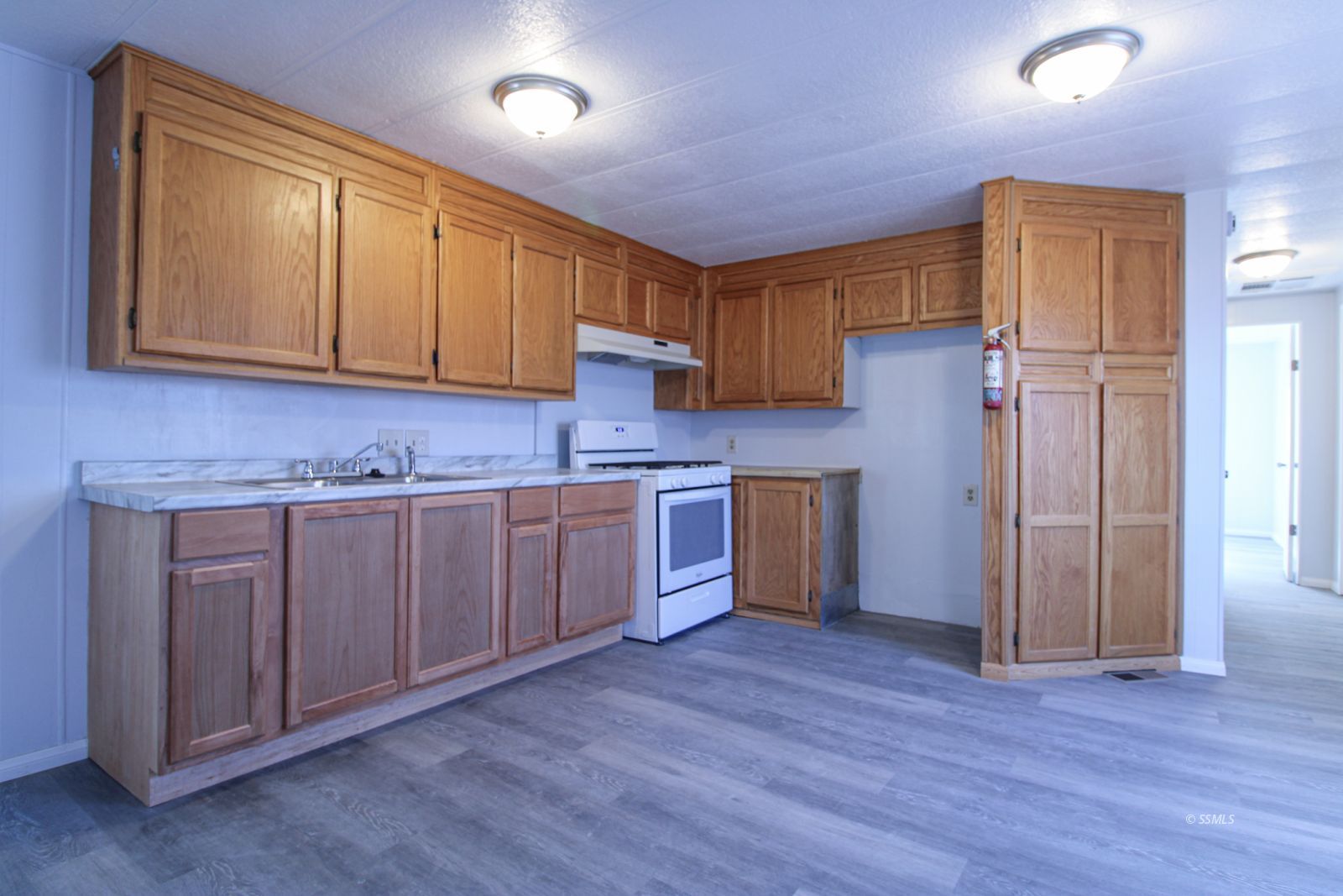 1441 West Iowa Avenue Ridgecrest, CA 93555 - Photo 8 of 27 a kitchen with a sink cabinets and wooden floor