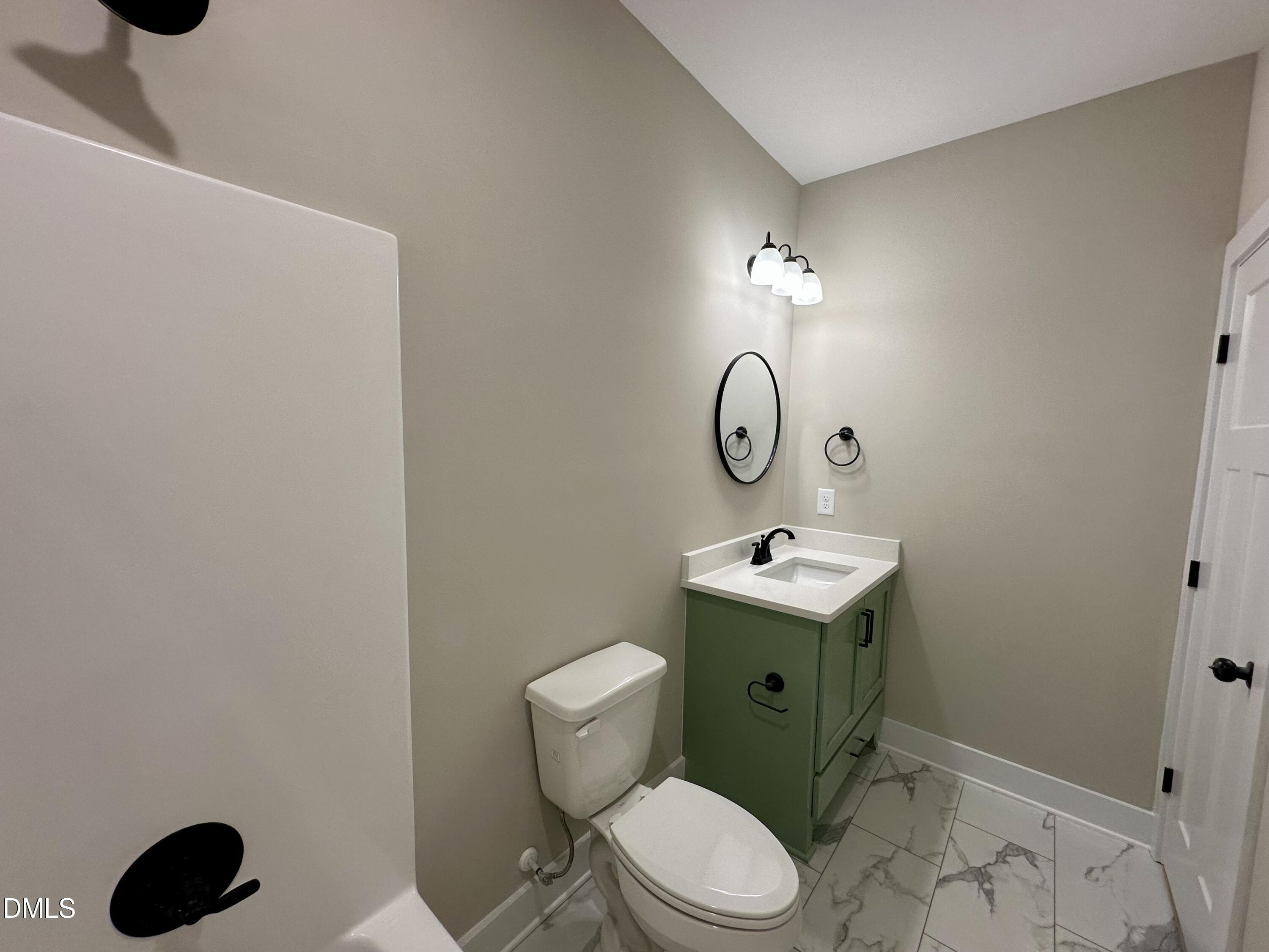 165 Bay Valley Road Kenly, NC 27542 - Photo 16 of 22 a bathroom with a toilet sink and mirror