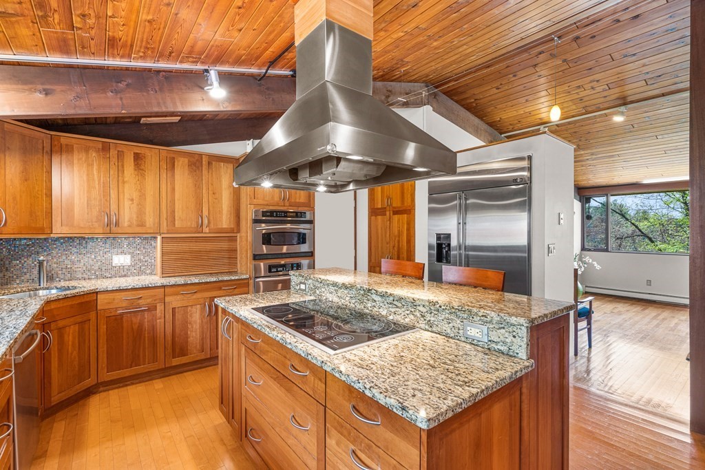 65 Spring Grove Road Andover, MA 01810 - Photo 21 of 41 a kitchen with stainless steel appliances granite countertop a sink stove and cabinets