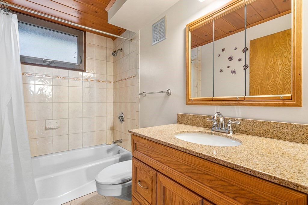 65 Spring Grove Road Andover, MA 01810 - Photo 29 of 41 a bathroom with a granite countertop sink a toilet and shower