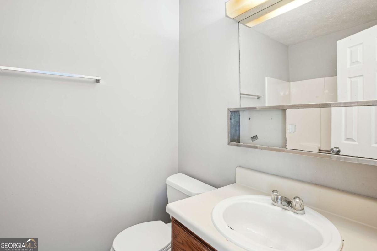 2049 Charter Lane Lithonia, GA 30058 - Photo 12 of 25 a bathroom with a sink and a toilet