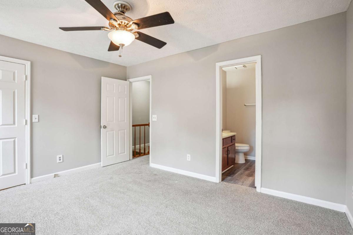 2049 Charter Lane Lithonia, GA 30058 - Photo 16 of 25 a view of a room with a ceiling fan and a bathroom