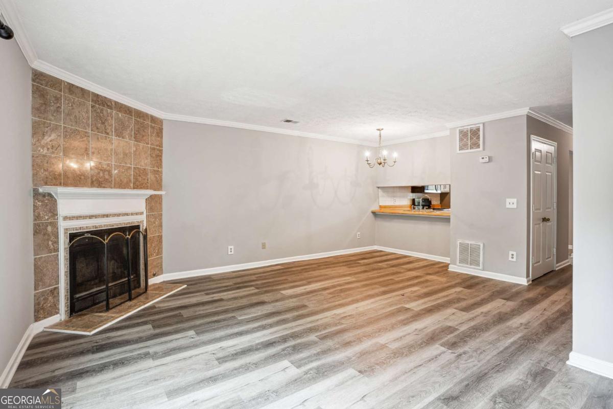 2049 Charter Lane Lithonia, GA 30058 - Photo 7 of 25 a view of empty room with wooden floor and fireplace