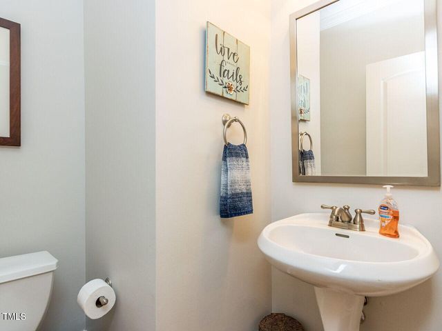 a bathroom with a sink a toilet and mirror