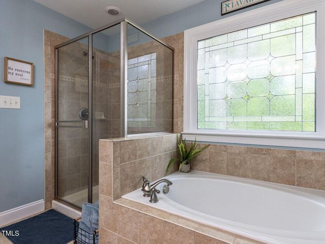 a bathroom with a bathtub and shower