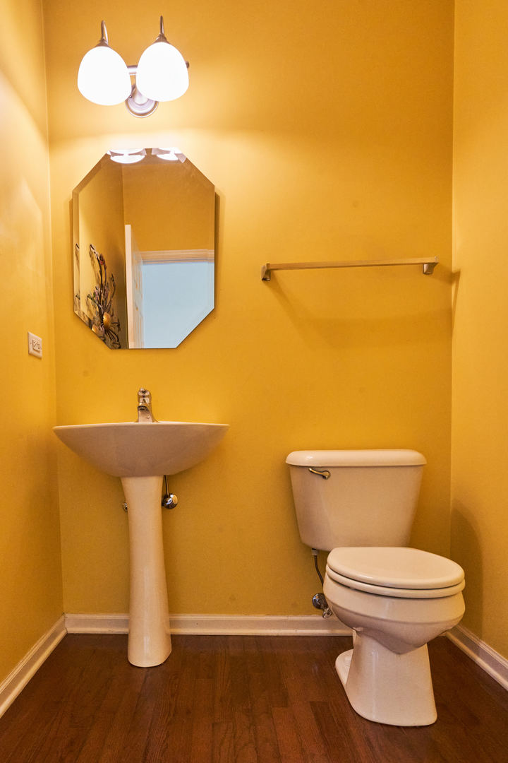 4114 Bethlehem Road Aurora, IL 60504 - Photo 5 of 28 a bathroom with a toilet and a mirror