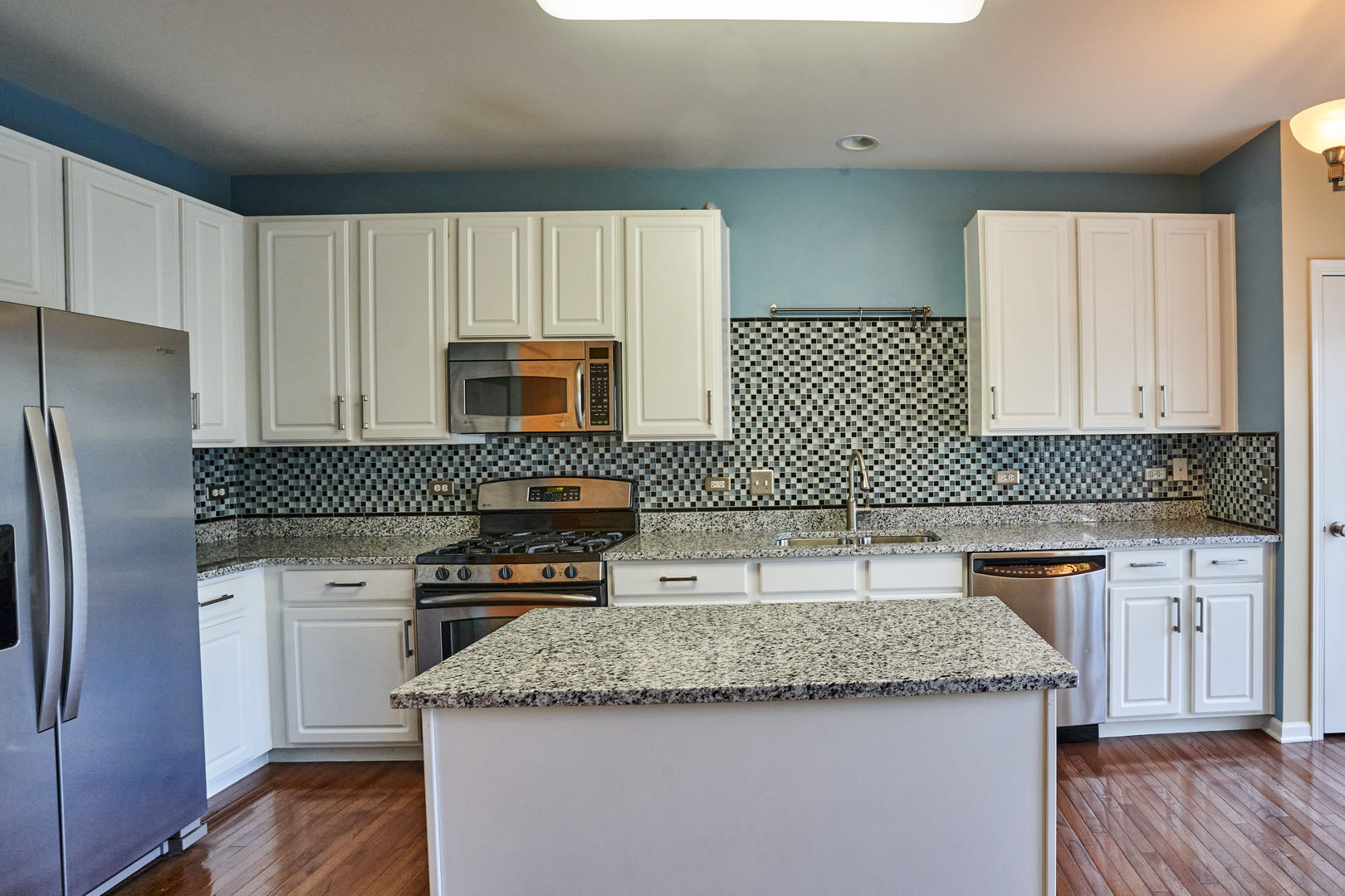4114 Bethlehem Road Aurora, IL 60504 - Photo 9 of 28 a kitchen with granite countertop a sink stove and refrigerator