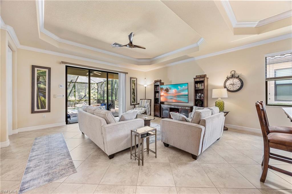 9234 Veneto Place Naples, FL 34113 - Photo 11 of 38 a living room with furniture and a large window