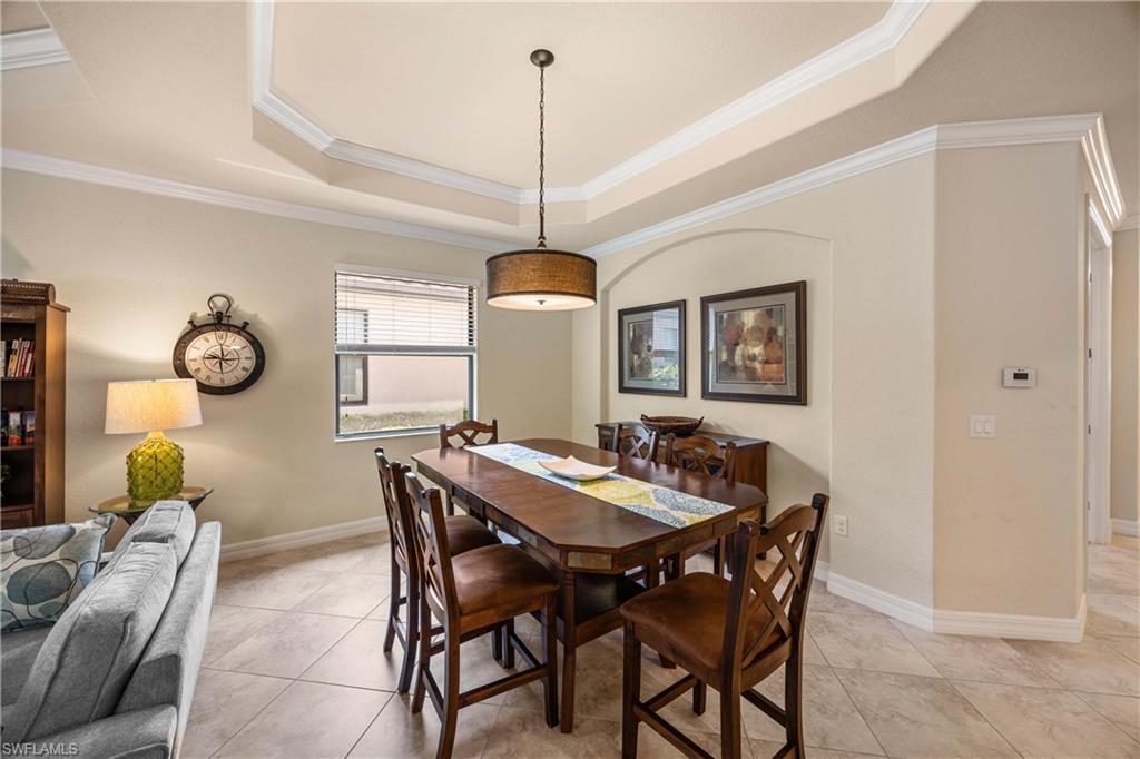 9234 Veneto Place Naples, FL 34113 - Photo 12 of 38 a dining room with furniture and window