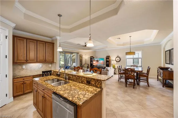 a large kitchen with stainless steel appliances granite countertop a stove refrigerator and cabinets