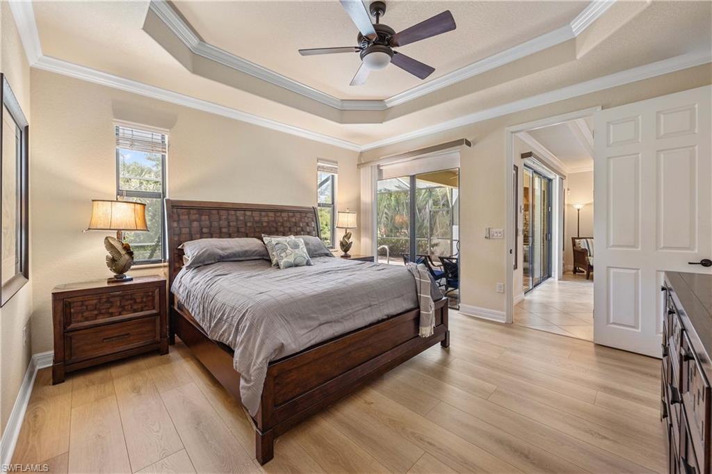 9234 Veneto Place Naples, FL 34113 - Photo 17 of 38 a bedroom with a bed lamp closet and window